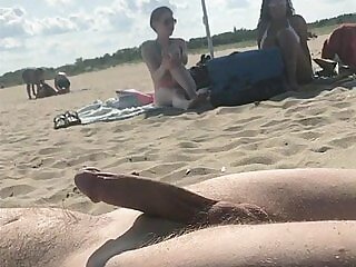 Cumming on a public beach in front of two girls